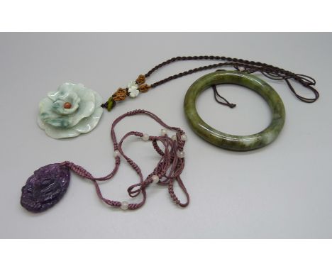 A jade bracelet, a carved jade necklace and a lavender jade pendant 