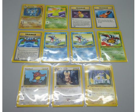 Eleven base set first edition Pokemon cards including Machamp holographic 