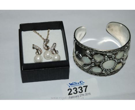 A 925 Silver Necklace and Ear-ring set and a Mother of Pearl silver Bangle.