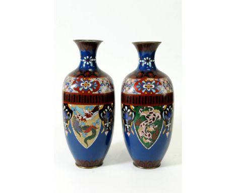 A pair of Chinese cloisonné enamel vases of squared baluster form with pinched necks and flared rims, the blue ground dispers