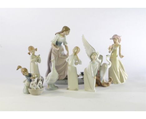 Eight pieces of Nao and Lladro including a figural group of a puppy tugging at a lady's dress, 30cm high, a girl with her arm