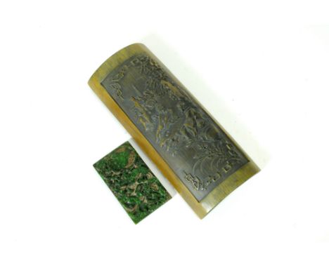 A Chinese carved bamboo wrist rest, carved from a single panel, detailing a pair of figures, seated in conversation before di