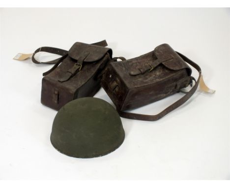 A pair of Swedish brown leather ammunition cases and a British military helmet