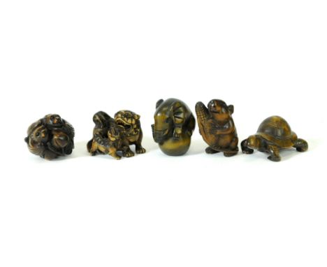 A group of five carved Chinese and Japanese hardwood Netsuke including an example in the form of two bats resting upon peache