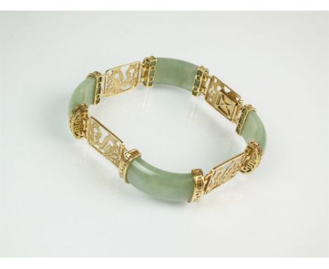 A 9ct gold jade panel bracelet, designed as four arched rectangular jade panels each interspersed with pierced 9ct gold drago