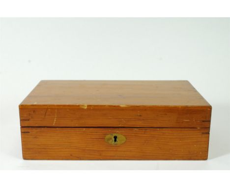 A 20 th century wooden cased games box, the locking hinged lid opening to reveal a compartmental interior containing an assor