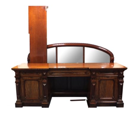 A large and impressive Victorian mahogany pedestal sideboard, the architectural frieze accommodating three drawers flanked wi