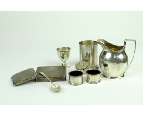 A George III silver cream jug, London 1798, 11cm high, together with a silver egg cup, a silver mug, an engine turned silver 