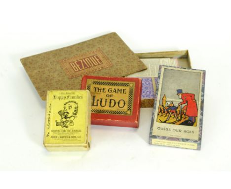 A mixed collection of early 20th century board games and puzzles to include boxed table tennis, Scrabble De Luxe, Bezique, Lu