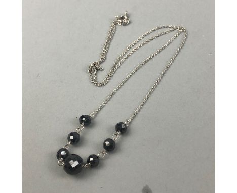 BLACK MOISSANITE BEAD NECKLACE, set with seven faceted beads, the chain marked 925, along with a ruby and black moissanite ne