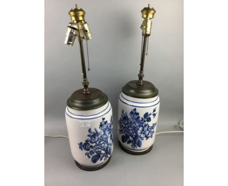 PAIR OF DELFT STYLE BLUE AND WHITE CERAMIC TABLE LAMPS, each decorated with blue flowers on a white ground, 64cm high