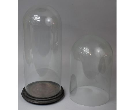Two Late 19th Century Glass Domes, The First being 21cm Diameter and 32cm high and the Second Example with Circular Wooden Ba