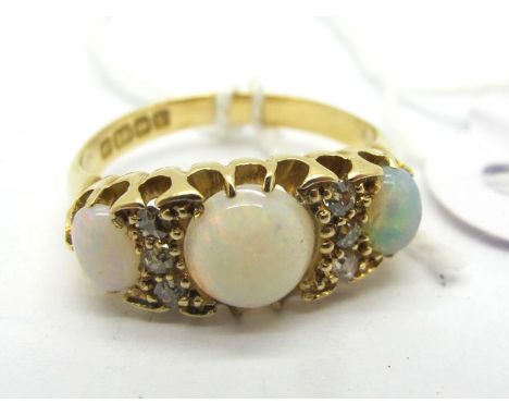 An 18ct Gold Opal and Diamond Set Ring, graduated set, Birmingham 1920 (finger size M). 