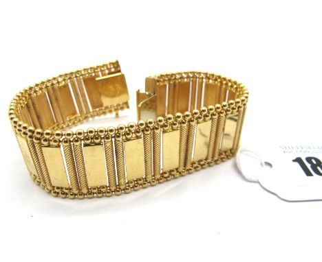 A Fancy Link Panel Bracelet, of uniform geometric design, to snap clasp, stamped "750", 19.5cm long (39grams). 