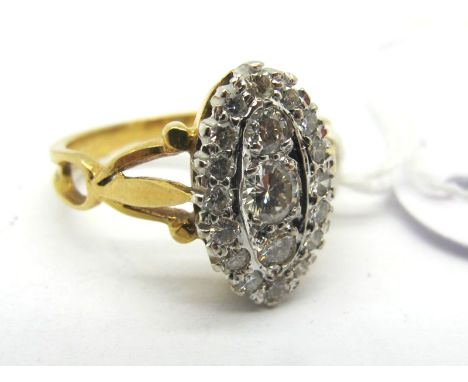 An 18ct Gold Diamond Set Ring, of Edwardian style, claw set between trifurcated openwork shoulders (finger size N1/2). 