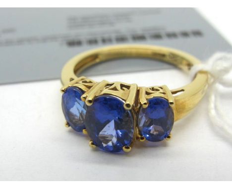 A Modern Iliana 18ct Gold Tanzanite Three Stone Ring, graduated oval claw set, stamped "ILIANA" (finger size P). *Authenticit