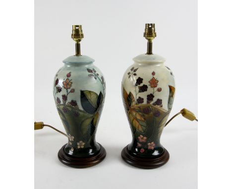 Two Moorcroft lamp bases in blackberry bramble pattern, one on cream ground another blue, 26.5 cm excluding fittings .   