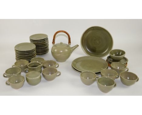 Leach Pottery, St Ives, Two celadon glazed plates incised with oak leaves, similarly decorated bowl and cover, shallow bowl w