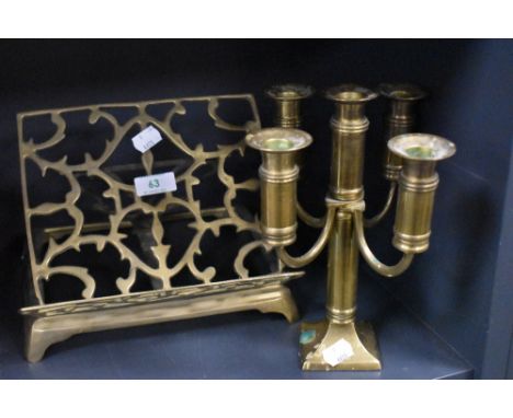 A brass book rest and a candlestick.