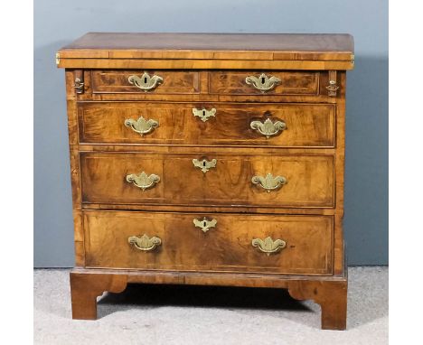 A George II bachelors walnut chest, the top and front inlaid with herringbone bandings and crossbanded, the folding top with 