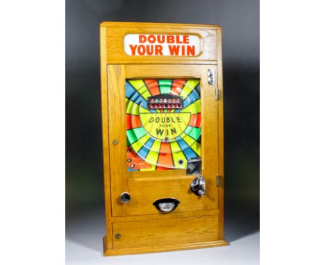 A 1950s oak cased "Penny-in-the Slot" "Double Your Win" Alwin flicker machine with "2-4-6" pay-out, with multicoloured back p