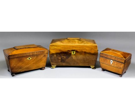 A George III mahogany tea caddy of sarcophagus shape, the whole inlaid with boxwood stringings, the interior with two lidded 