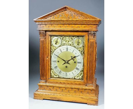 A late Victorian oak cased mantel clock, the 9ins brass dial with silvered chapter ring with Roman and Arabic numerals and wi