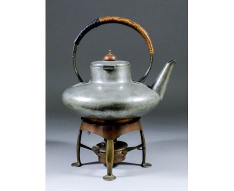 A "Tudric" pewter, copper and brass tea kettle on, stand, Model No. 01098, the kettle of circular bulbous form with wicker wo