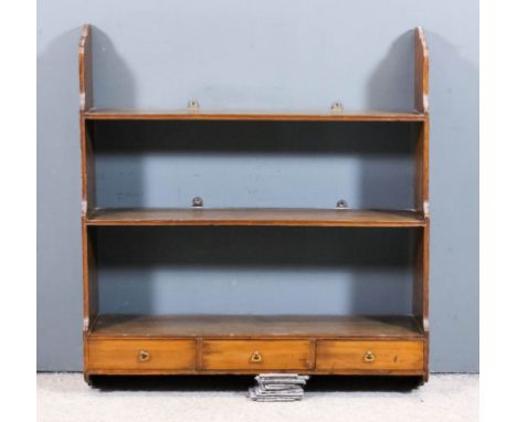A George III mahogany three tier open front waterfall wall shelf, fitted three drawers to lower tier, 34ins wide x 9.75ins de