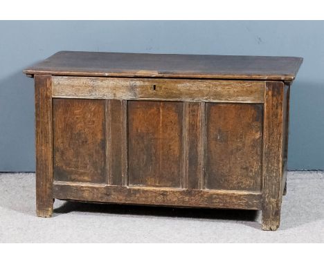 A 17th Century panelled oak coffer with plain lid, the three panels to front with moulded rails, 36ins wide x 17ins deep x 20