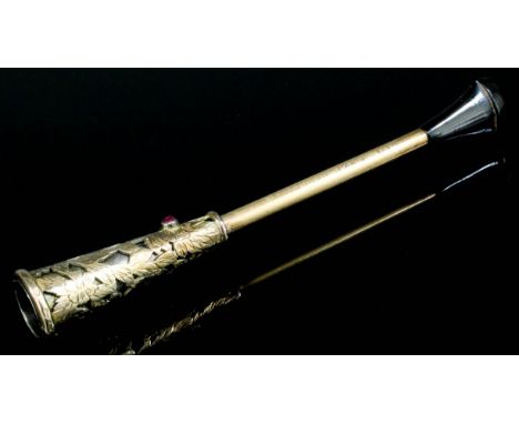 A 1920's lady's gold coloured metal garnet set cigarette holder by Boucheron of Paris, No. 83895, the floral cast holder set 