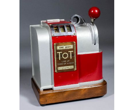 A 1940s American "One Cent-in-the-Slot" "Tot" counter top trade stimulator by Western Manufacturers, the curved aluminum fron