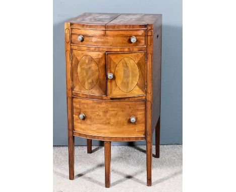 A George III mahogany bow front enclosed wash stand, the top opening to reveal a bowl cut-out, fitted one dummy drawer above 