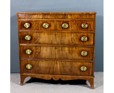 A late Georgian North Country mahogany chest with crossbanded top and inlaid with stringings, fitted three narrow frieze draw