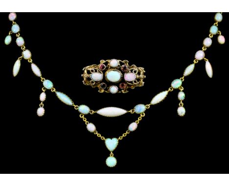 A late Victorian gold coloured metal mounted and white opal necklet, set with fifty one oval, ovoid, and heart pattern drops,