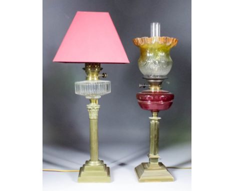 A late 19th Century brass oil lamp of Corinthian column form, on stepped square base, with cut glass reservoir, 22.75ins high