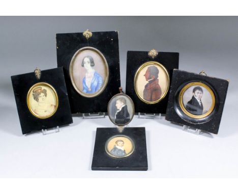 A late 18th/early 19th Century miniature shoulder-length portrait of a young man with blue frock coat, oval 2.5ins x 2ins, an