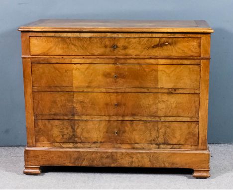 An early 19th Century French walnut commode of "Empire" design, with plain cleated top, fitted four long drawers and block to