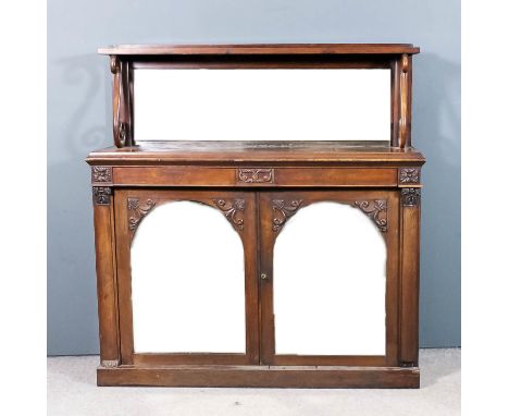 A Victorian faded rosewood chiffonier with low mirror panel back, with one shelf and S-scroll supports, the base fitted two n