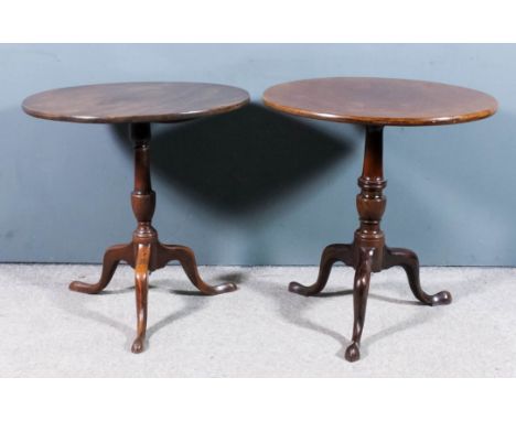 A George III mahogany circular tripod table with one piece top, on turned central column and cabriole legs with pad feet, 28i