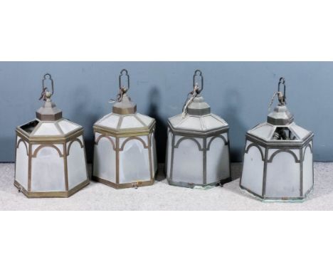 Four 1920s brass framed hexagonal hall lanterns of slight flared form, inset with frosted glass panels. 25ins high overall x 