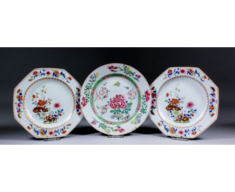 A pair of Chinese octagonal famille rose plates, painted with flowering chrysanthemum and prunus amongst rockwork, each 8.5in