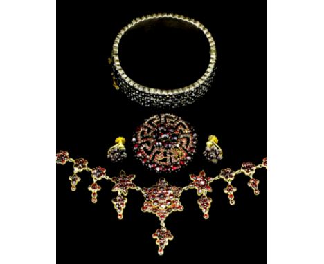 A late Victorian gilt coloured metal mounted garnet set suite of jewellery comprising a necklace of flowerhead form, 480mm ov