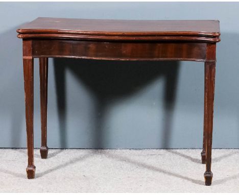 A George III mahogany serpentine fronted card table, the baize lined folding top with rounded moulded edge, with plain apron,