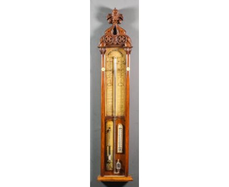 A late Victorian oak cased "Admiral Fitzroy's" barometer with exposed tube and mercury thermometer, and the atmosphere contai