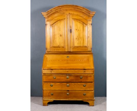 A 19th Century Continental stripped pine bureau cabinet, the upper part with deep arched and moulded cornice, fitted one shel