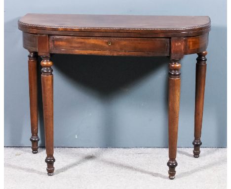 A George III mahogany D-shaped card table with baize lined folding top and bead edge mouldings, the apron fitted one frieze d