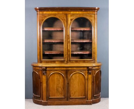 A Victorian figured mahogany chiffonier bookcase, the upper part with moulded cornice and rounded front corners, fitted three