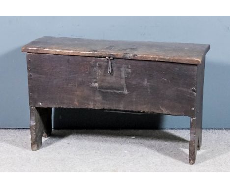 A 17th Century oak plank coffer with shaped ends, 32.25ins x 13.75ins x 20ins high (with patch repair to lid and front) Prove