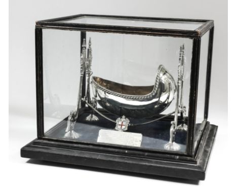 A George V silver and silver gilt model of a cradle of oval form and with gadroon mounts, on twin leaf cast scroll end suppor